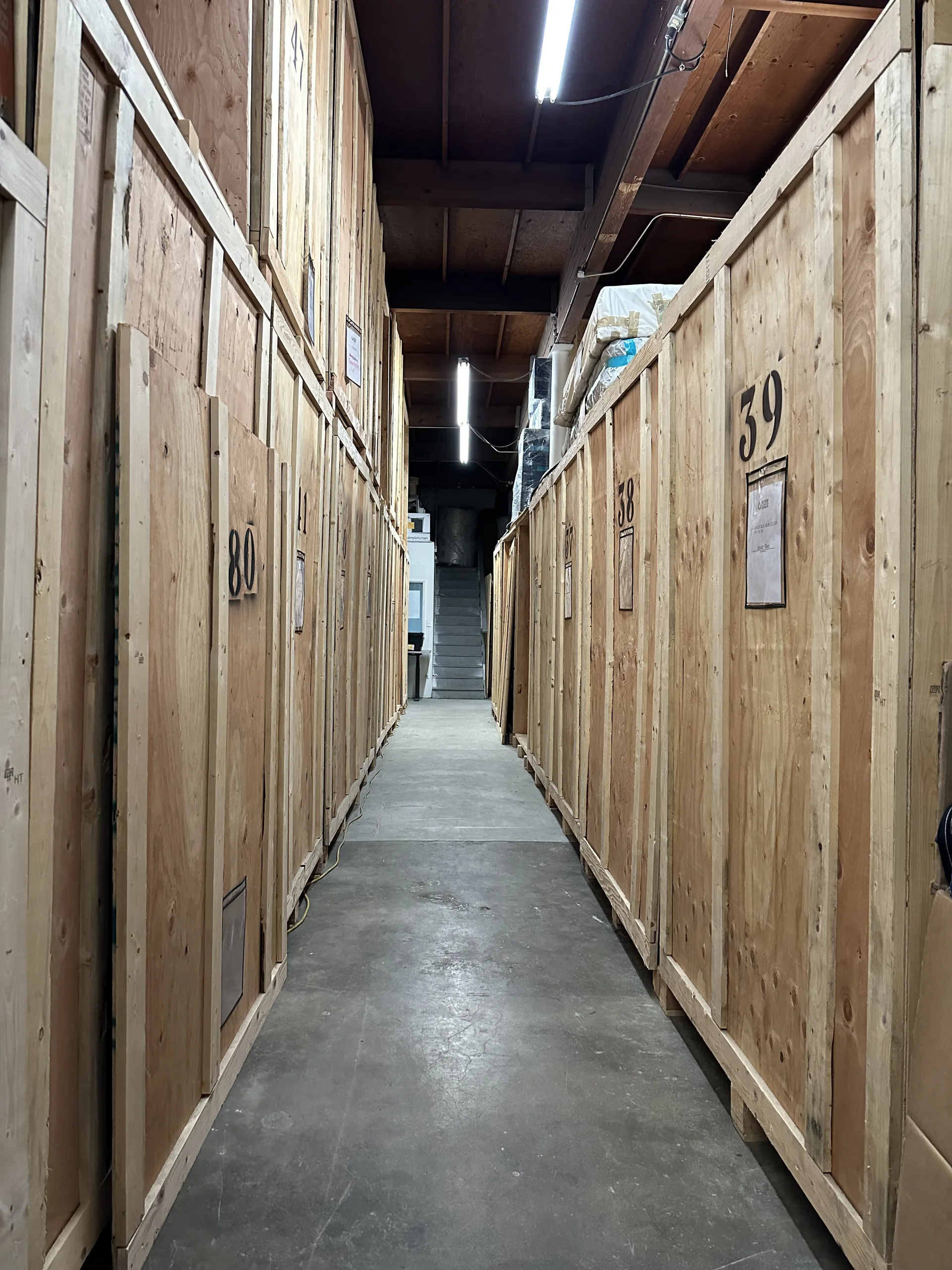 Aisle of numbered, climate-controlled wood storage vaults at the Contents by Save The Day facility in Signal Hill