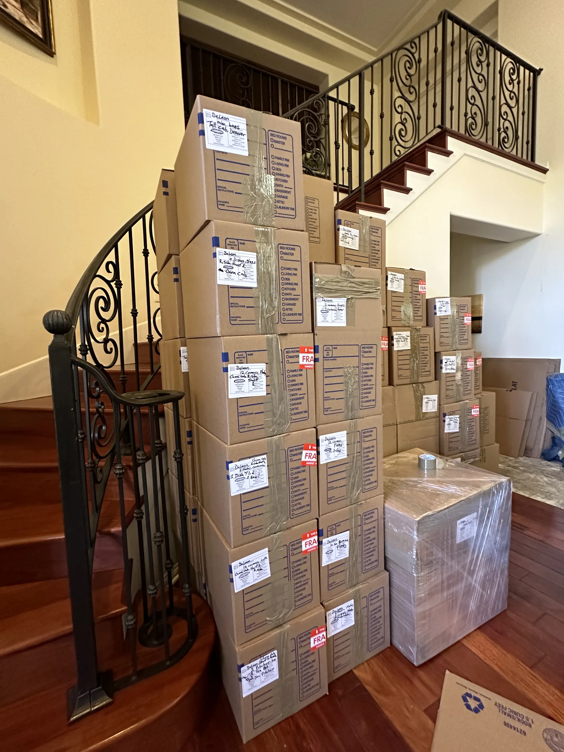 Closely labeled stack of contents cartons documenting household items during a professional pack-out