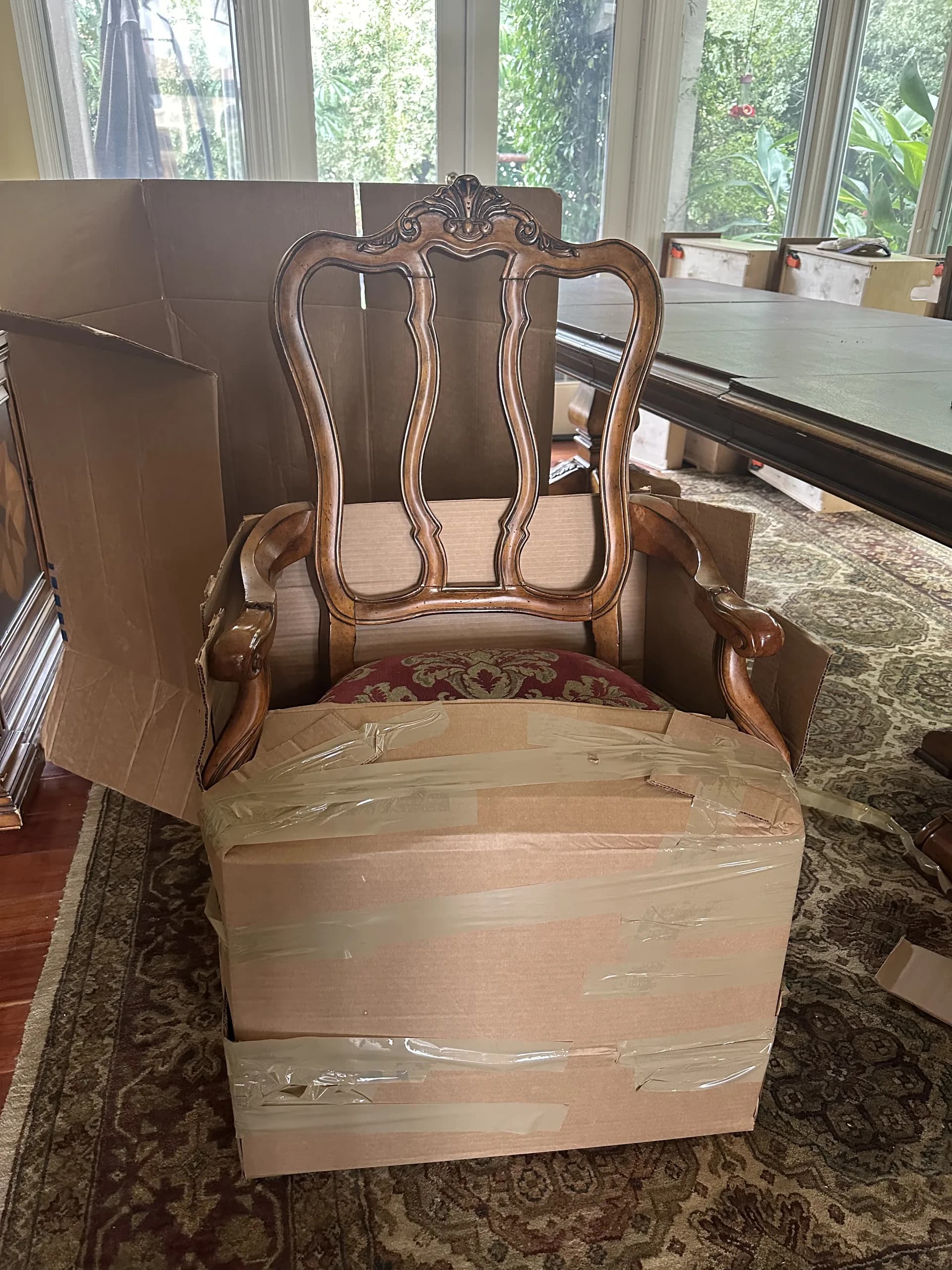 Antique carved armchair being custom-boxed and protected during a high-value contents pack-out